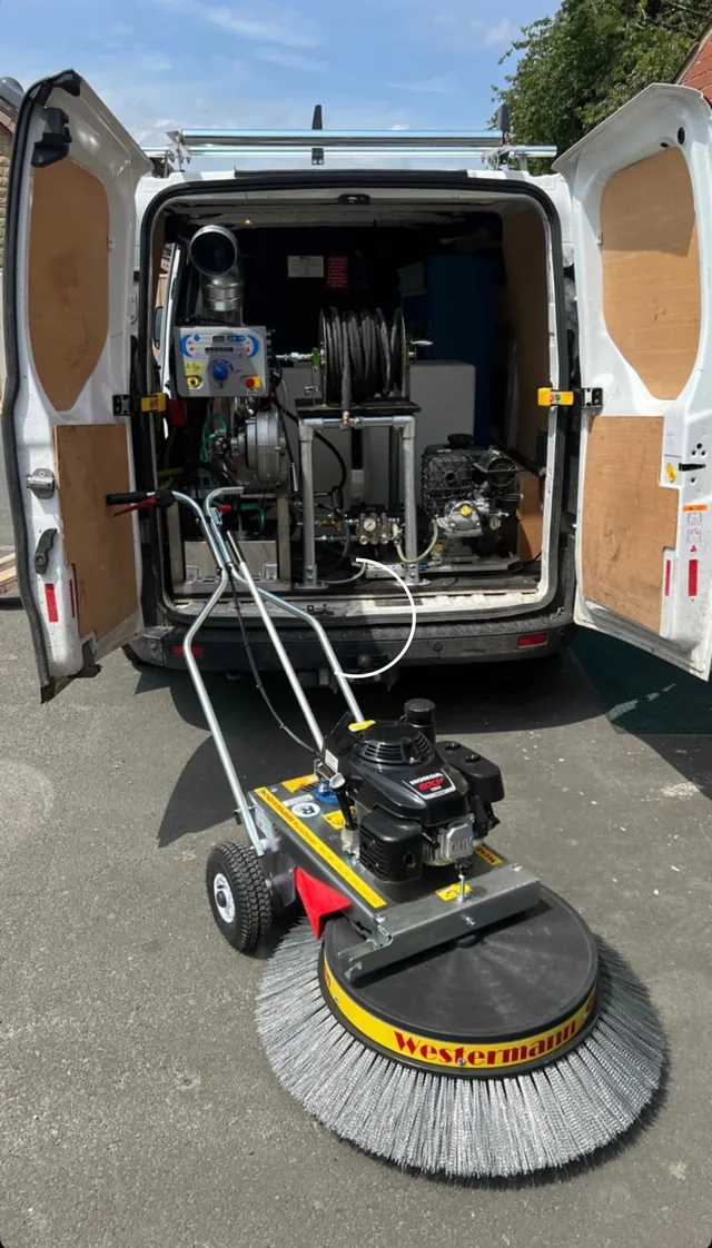 Pressure-washing equipment beside the WillPower Washing van