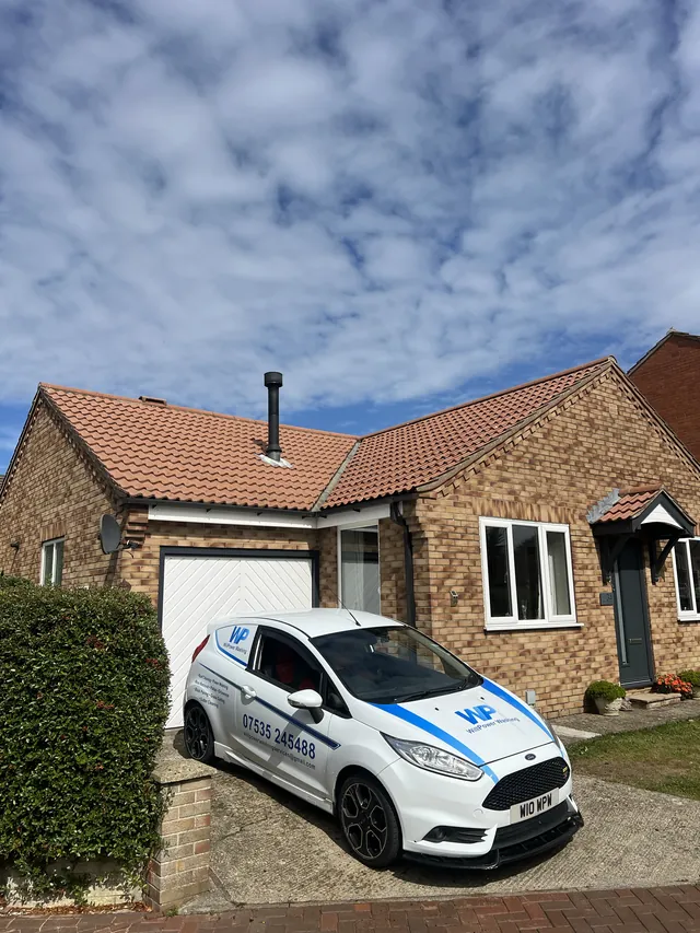 WillPower Washing van outside a house with a cleaned tiled roof